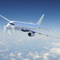 Airplane in the sky, over the cloudy sky