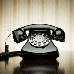Vintage telephone over striped wallpaper