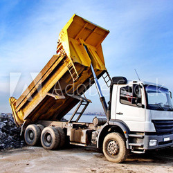 Dump truck is dumping gravel on an excavation site