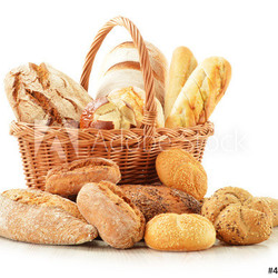 Bread and rolls in wicker basket isolated on white