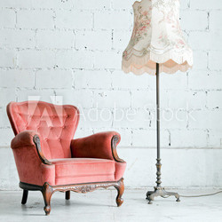 Armchair with desk lamp in vintage room