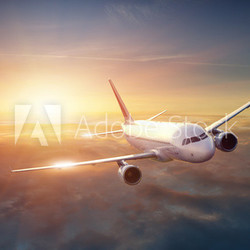 Airplane in the sky at sunset