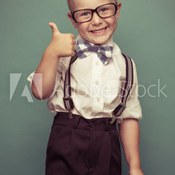 Cheerful smiling funny boy on a green background.