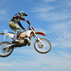 High flight by motorcycle racer motocross against the blue sky