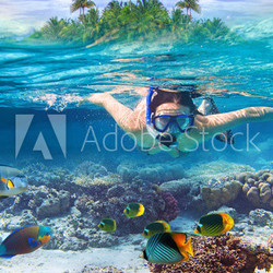 Young women at snorkeling in the tropical water