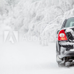 Black land vehicle standing on winter road on roadside