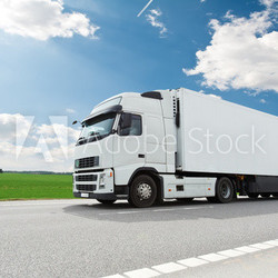 white lorry with trailer over blue sky