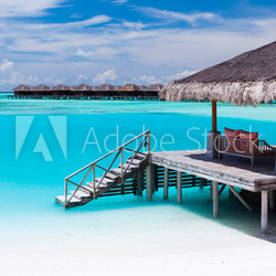 Over water jetty with steps into tropical lagoon