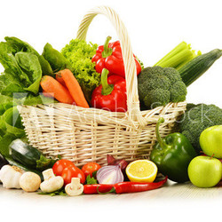 raw vegetables in wicker basket isolated on white