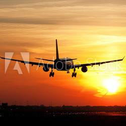 Plane landing in sunrise