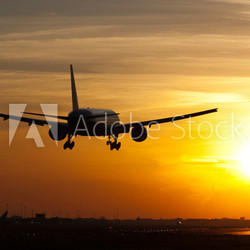 Plane landing in sunrise