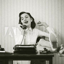 Woman talking on phone at desk