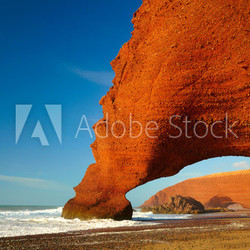 Red archs on atlantic ocean coast. Marocco