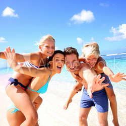 Family of four having fun at the beach