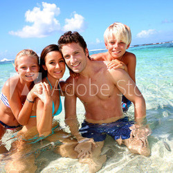 Couple and children in crystal clear water