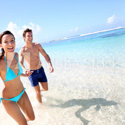 Couple running on a sandy beach