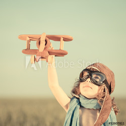 Happy kid playing with toy airplane