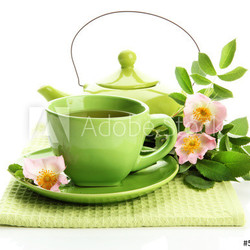 Cup and teapot of herbal tea with hip rose flowers, isolated