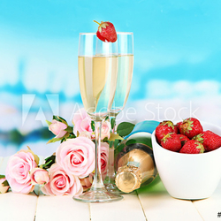 Romantic still life with champagne, strawberry and pink roses,