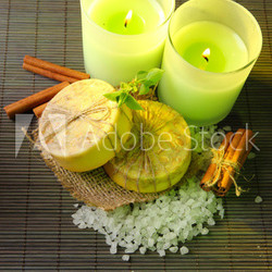 Hand made soap and candles on bamboo mat background