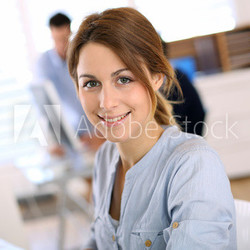 Portrait of cheerful girl in office