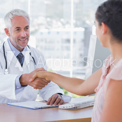 Doctor shaking hands to patient
