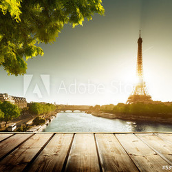 background with wooden deck table and  Eiffel tower in Paris