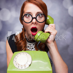 Redhead women with green telephone.