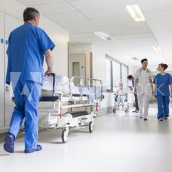 Doctors Hospital Corridor Nurse Pushing Gurney Stretcher Bed