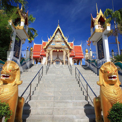 Golden lion guarding statues in Thai temple