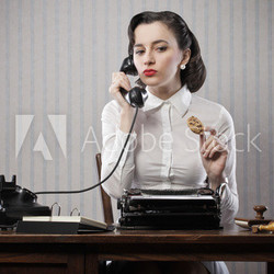 Woman talking on phone at desk