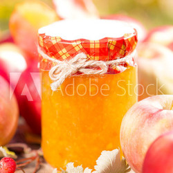 Apple jam and fruits on wooden table