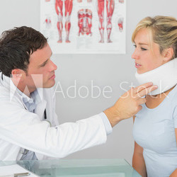 Attractive doctor examining neck of a patient