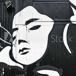 Woman face graffiti on a doorway