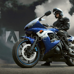 Man seat on the motorcycle under sky with clouds