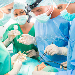 Surgeons operating patient in operation theater