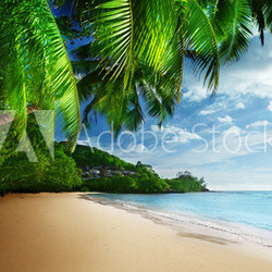 sunset on beach Anse Takamaka of Mahe island, seychelles