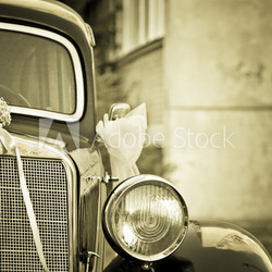 Old timer car with wedding decoration in sepia