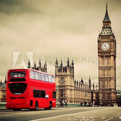 London, the UK. Red bus in motion and Big Ben
