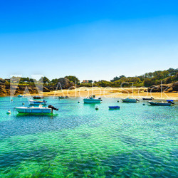 Tregastel, boats in beach bay. Pink granite coast, Brittany, Fra
